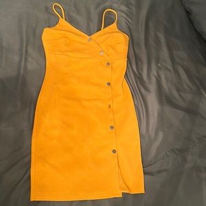 Mustard color mini dress, slight slit on left side, gold buttons down left side,